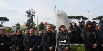 Varias personas oran por el Papa