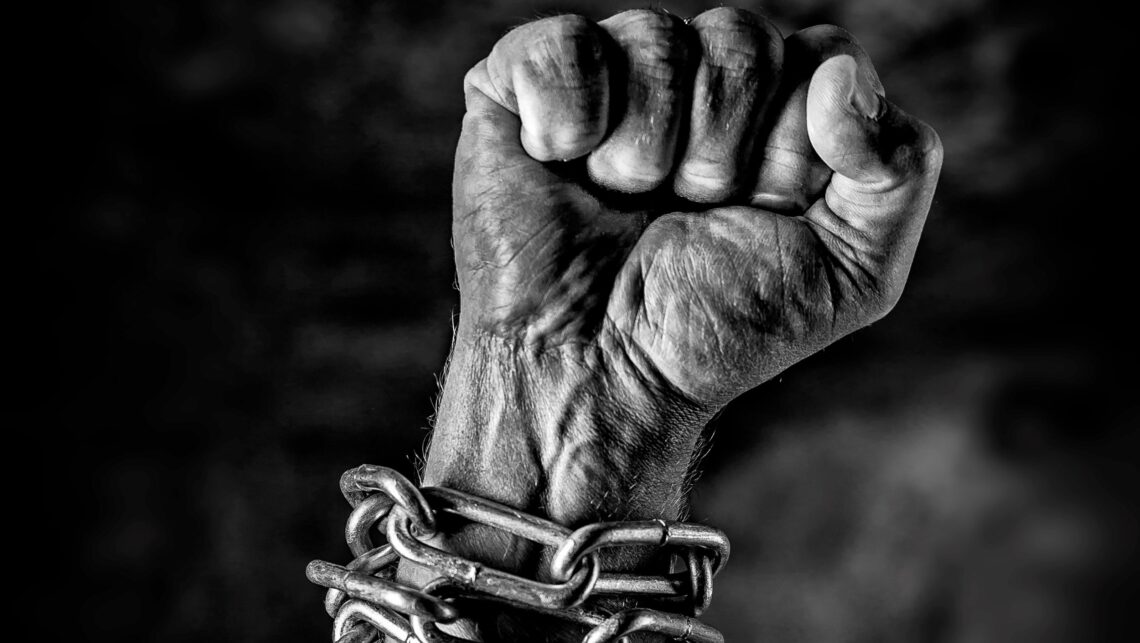 Arm in chains and the hand is closed as a fist, struggle free from oppression and tyranny ,