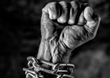Arm in chains and the hand is closed as a fist, struggle free from oppression and tyranny ,