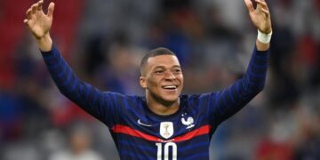 Mbappé con la camiseta de la selección francesa levanta los brazos