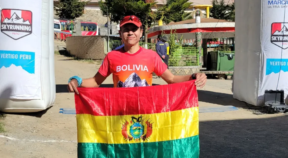 Álvaro Quemaya con la bandera nacional. Crédito: Skyrunning Bolivia