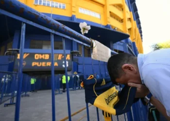 Un hincha de Boca Juniors besa la camiseta en homenaje al fallecido de Miguel Ángel Russo. (FOTO: AFP)