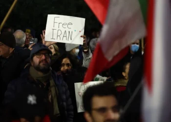 Una manifestante sostiene un cartel con la frase 'Irán libre' durante una protesta/AFP